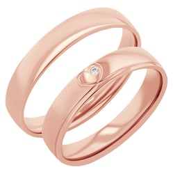 Goldene Eheringe mit einem Herzen und einem Diamanten Maline