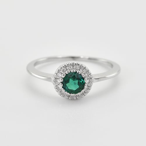 Goldener Halo Ring mit Smaragd umgeben von Diamanten Tafne