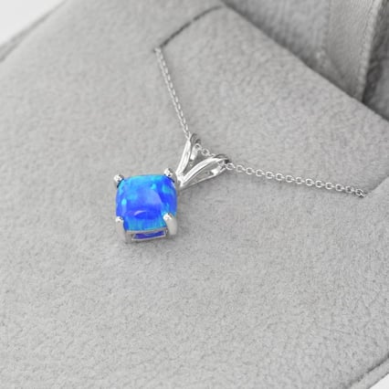 Goldener Anhänger mit blauen Topas Rafyna